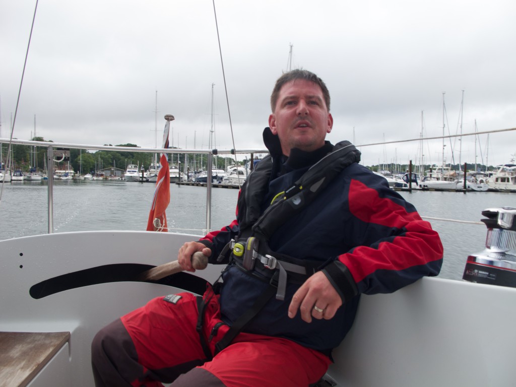 Skipper Peter May at the helm