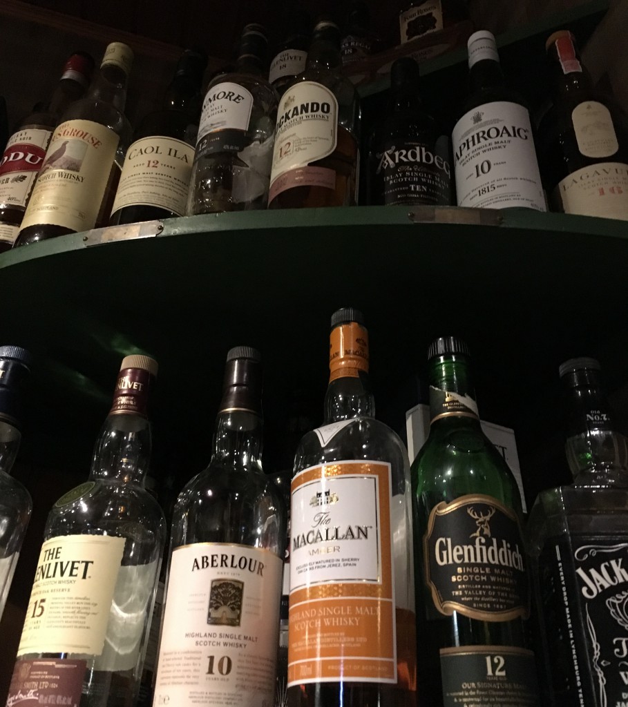 Well stocked shelf of single malt whiskies